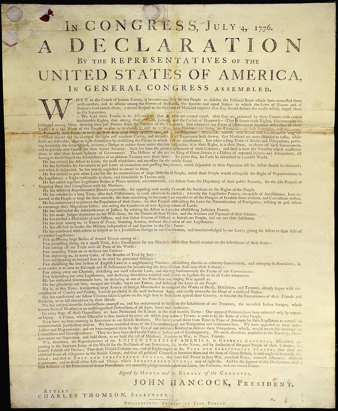 A stained single printed sheet headed In Congress, July 4, 1776, A Declaration by the Representatives of the United States of America, in dense eighteenth-century type, ending with the printed name John Hancock, President
