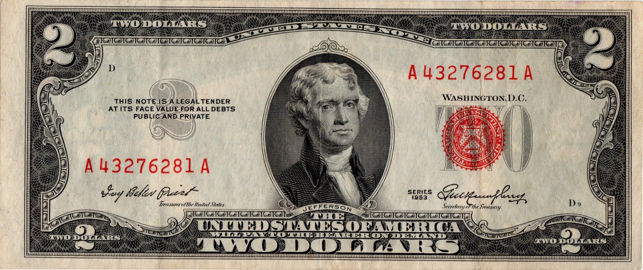 The front of a United States two-dollar bill with Thomas Jefferson's portrait in the center, a red seal and red serial numbers, marked series 1953