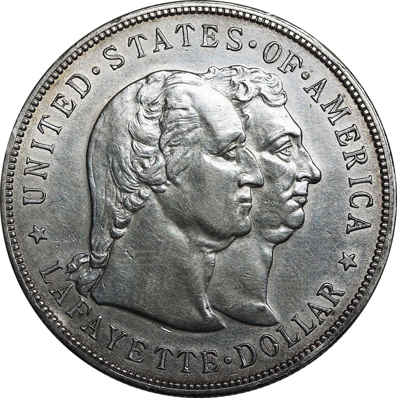 The face of a worn silver dollar coin showing two men in profile, one behind the other, ringed by the words United States of America and Lafayette Dollar