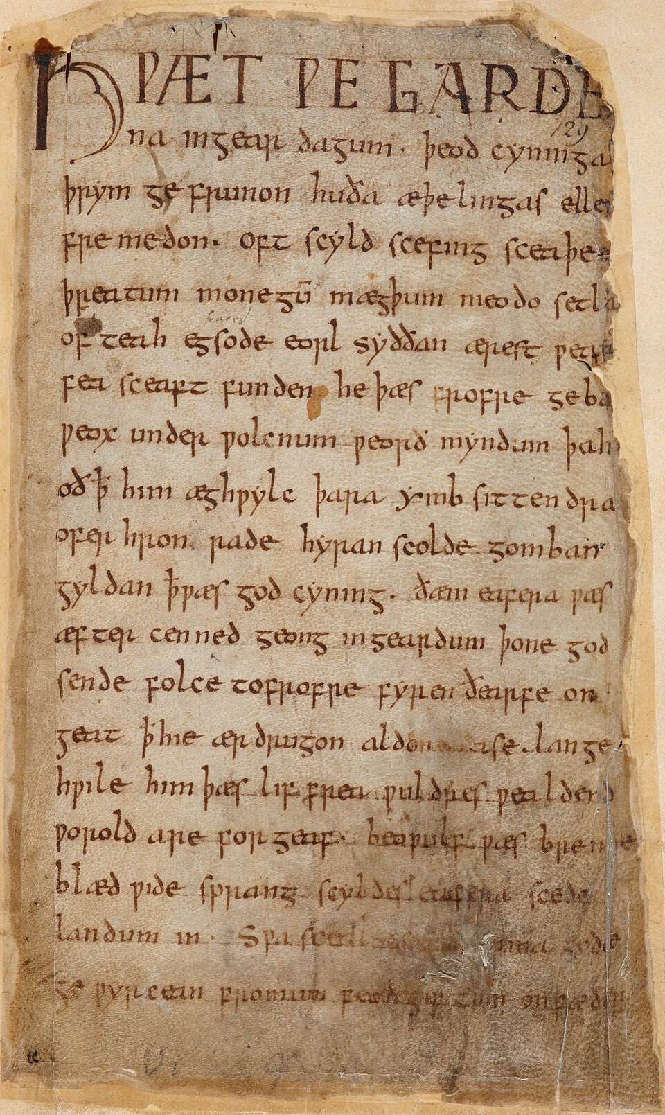 A browned parchment manuscript page covered in Old English handwriting, its large opening words written in tall dark capitals