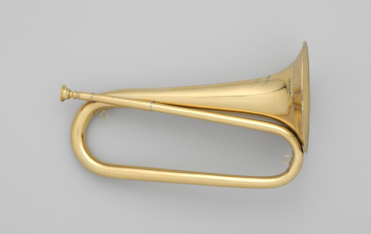A plain brass bugle photographed side on, a single looped tube widening into a bell, with a mouthpiece and no finger valves anywhere on it